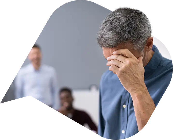 a man with his hand on his head after gross misconduct.