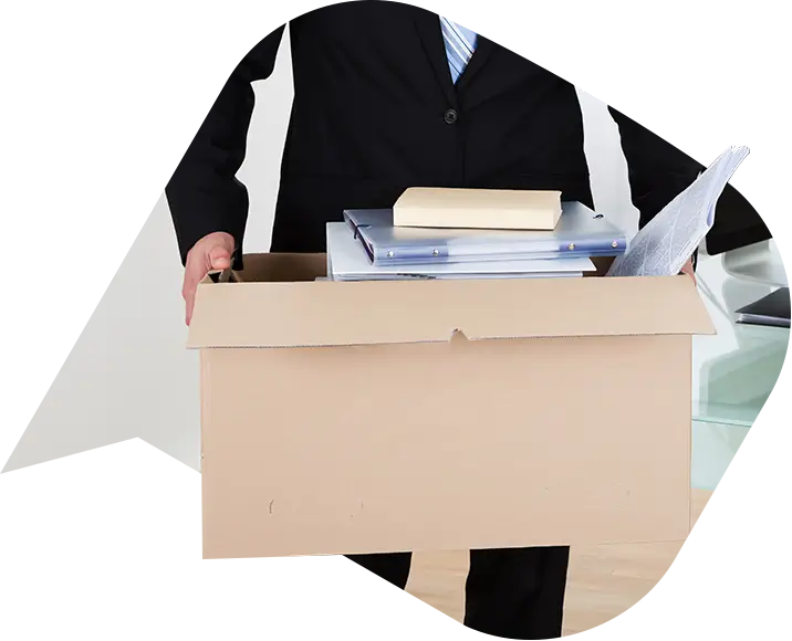 an employee holding a box leaving after being made redundant